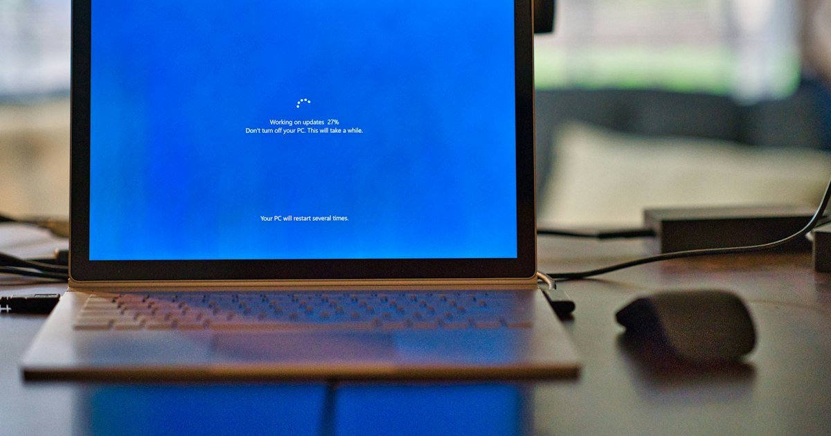 Laptop running Windows utility software on a desk