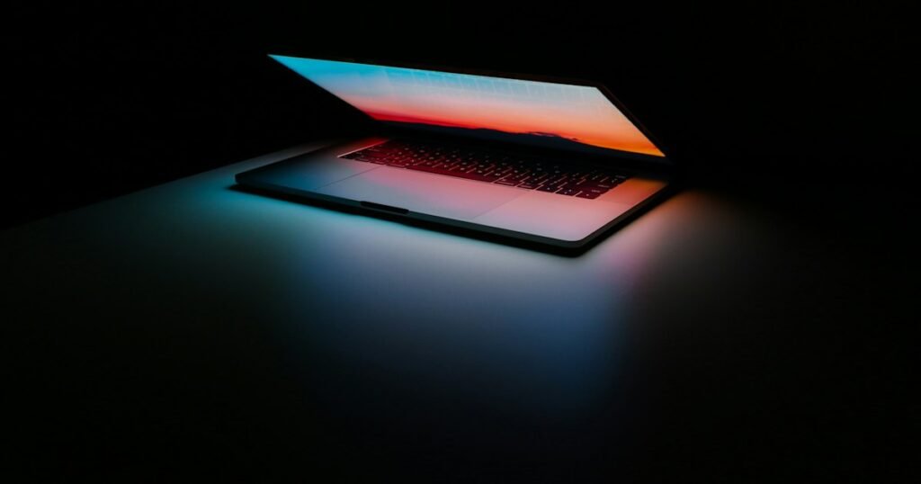 EaseUS vs AOMEI – laptop on a dark desk
