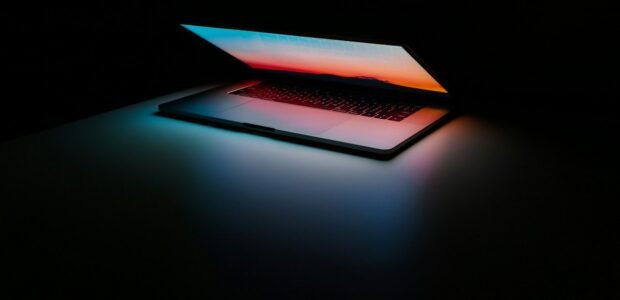EaseUS vs AOMEI – laptop on a dark desk