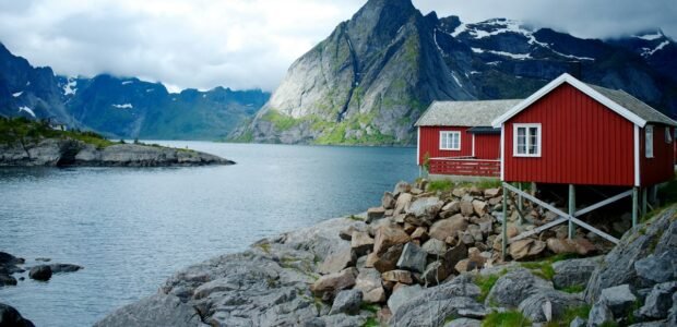 Hotels in Norway – red cabin by a Norwegian fjord