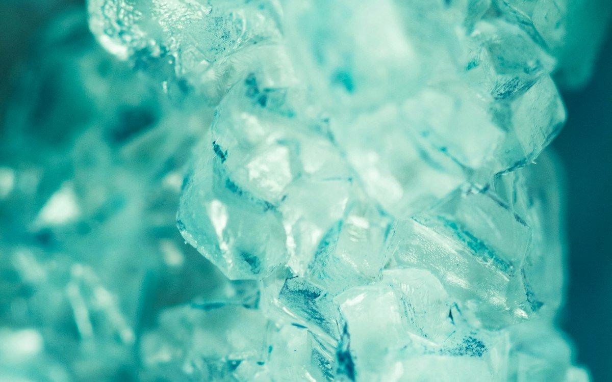 A bunch of ice cubes from a portable ice maker sitting on a table