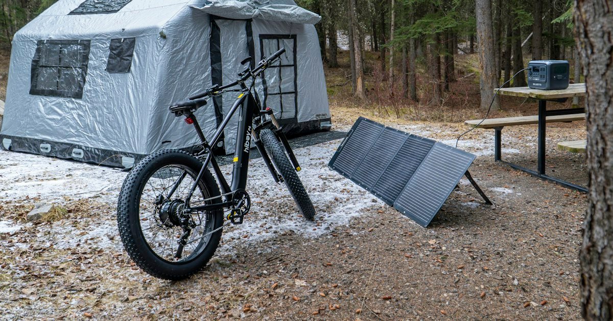 Solar panel recharging a portable power station at a campsite
