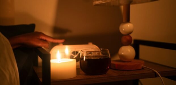 Home power outage lit by a candle and lamp