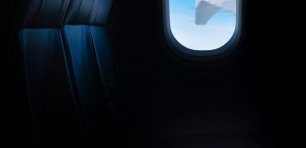 Airplane window seat with clouds outside, the kind of long-haul flight a Qatar Airways Black Friday fare deal is meant for