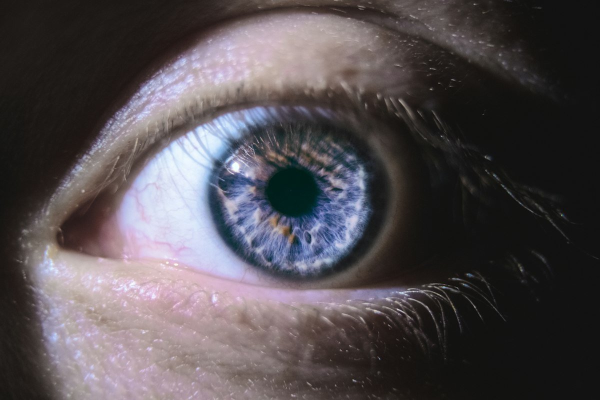 close-up photograph of a blue eye, illustrating the eye care routine CorneaCare products are built around
