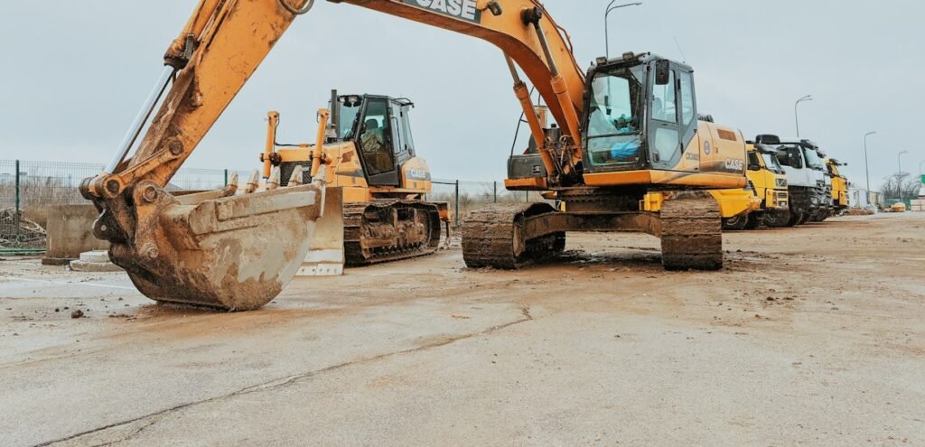 Yellow mini excavator used for a buying guide comparing weight classes and attachments