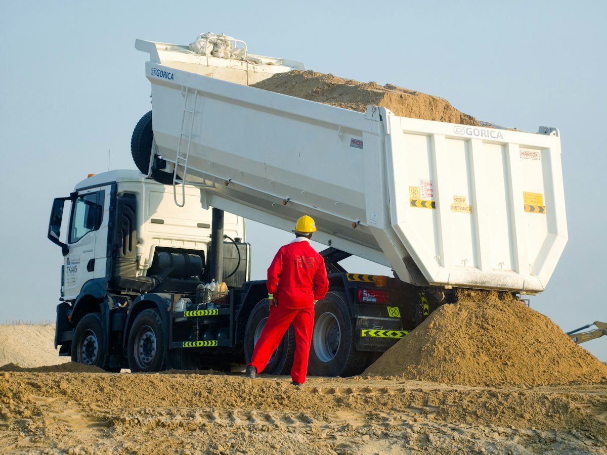 Worker following a mini excavator buying guide checklist on a job site with equipment similar to a Chery Industrial machine