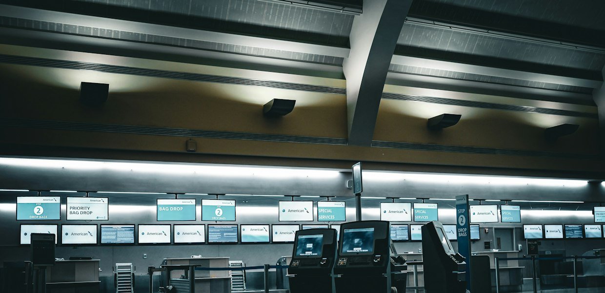 Empty airport check-in counters illustrating a Qatar Airways baggage allowance guide