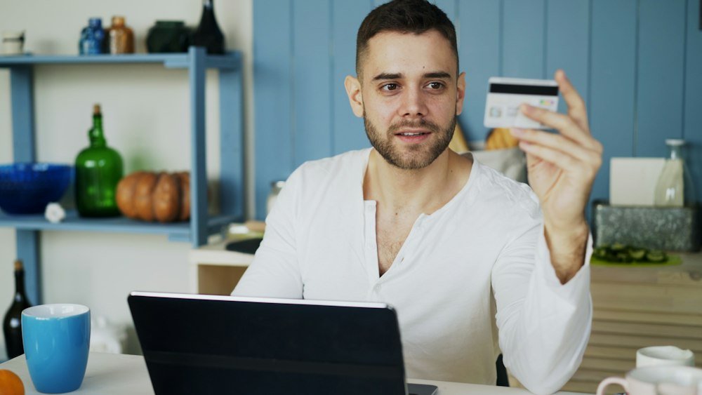 Shopper checking Cyber Monday prices on a laptop before paying with a credit card